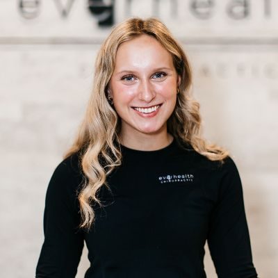 Chiropractic Chanhassen MN Cora Office Manager, Cora, smiling for photo wearing black top.